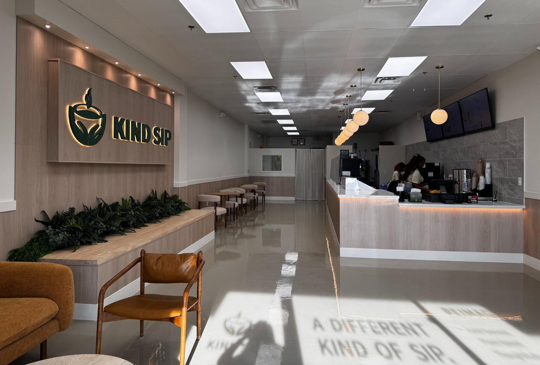 Interior of Kind Sip café with seating and a coffee bar